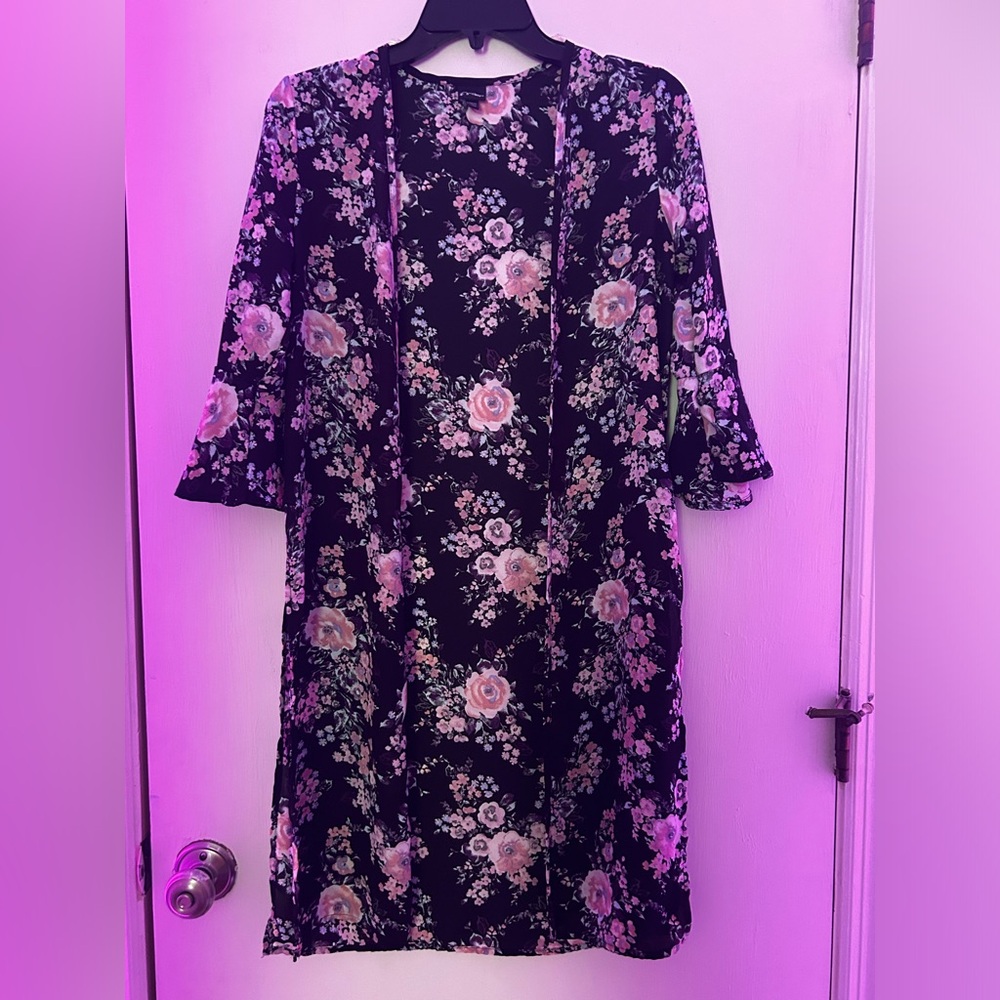 This is a Pink and black kids size 10-12 cardigan that is fairly used.